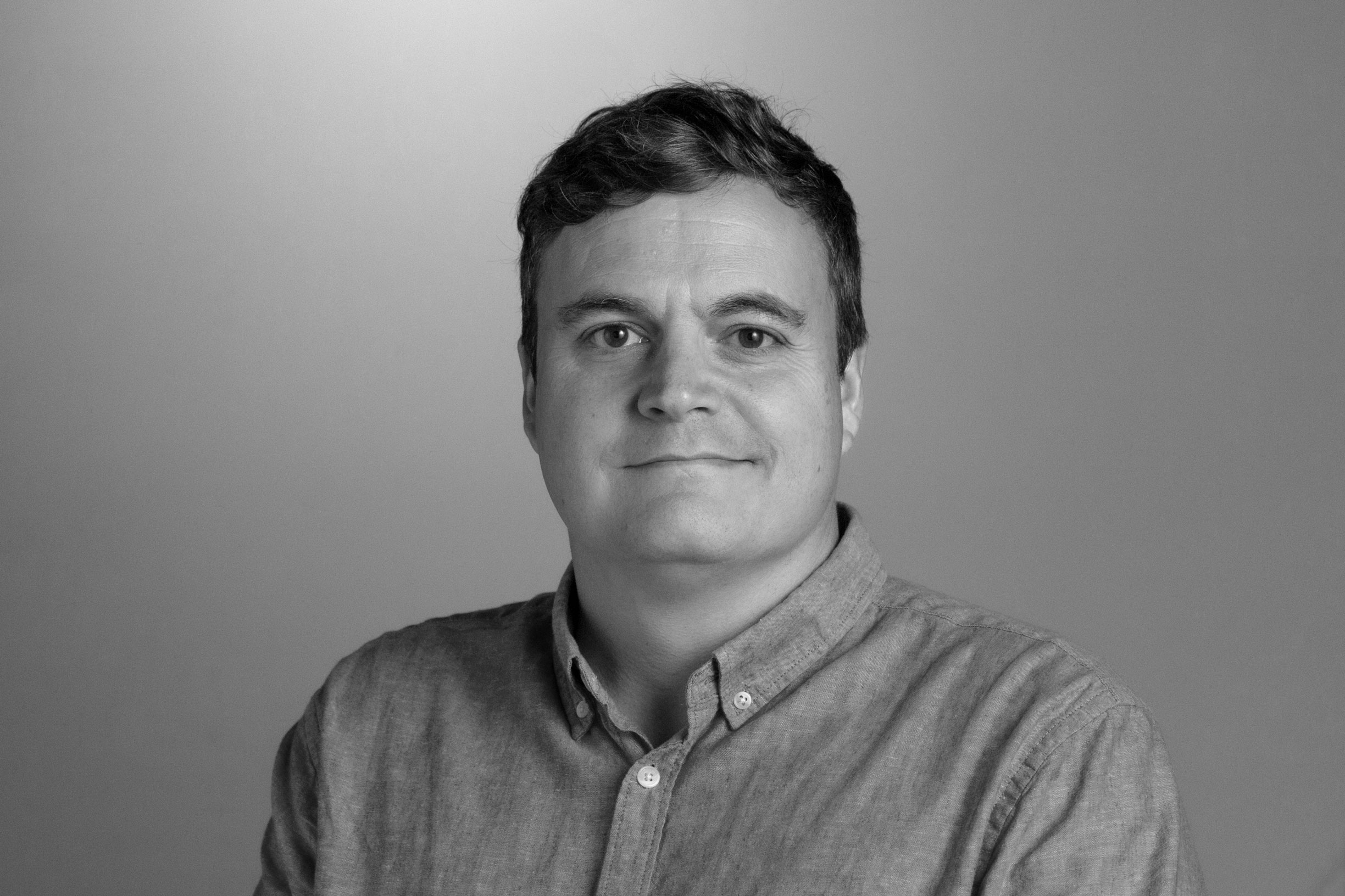 Headshot of Paul in black and white. 